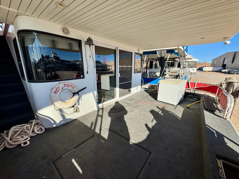 Slide: The Image of 2008 Sumerset Waterways Houseboat deck with life preserver and outdoor seating area. - 28