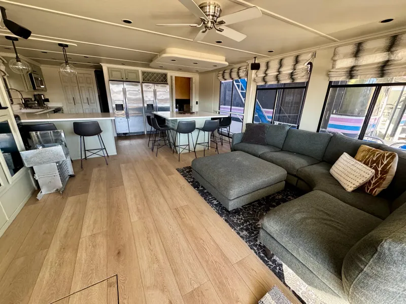 Slide: The Image of Spacious 2008 Sumerset Waterways houseboat interior with modern kitchen, cozy seating, and large windows. - 4