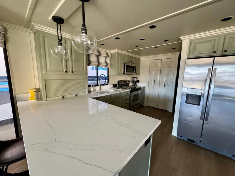 Slide: The Image of Modern kitchen in 2008 Sumerset Waterways Houseboat with sleek countertops and stainless steel appliances. - 5