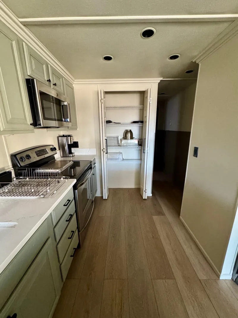 Slide: The Image of Modern kitchen in 2008 Sumerset Waterways houseboat with stainless steel appliances and wood flooring. - 8