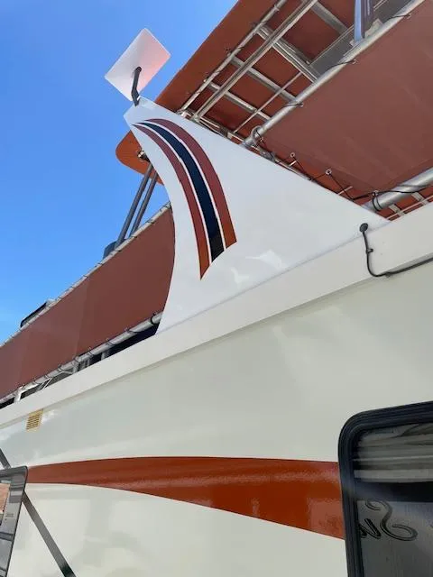 Slide: The Image of 2007 American Waterways Houseboat Sundancer Trip #17, side view with red and white design. - 3