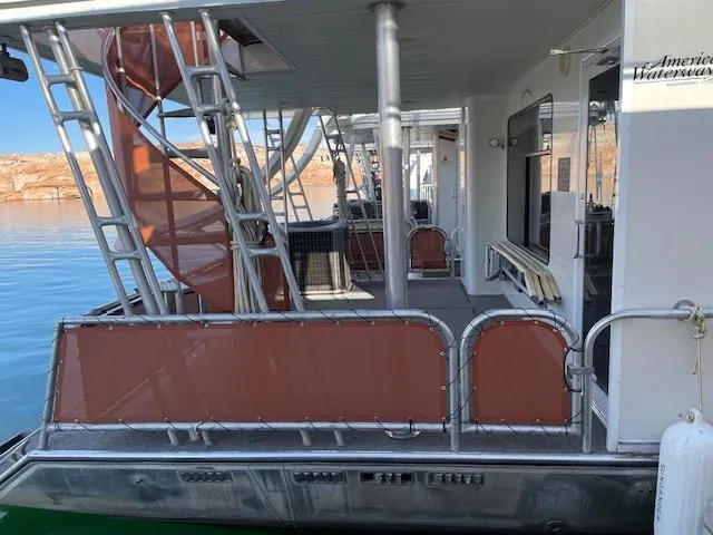 Slide: The Image of American Waterways Houseboat Sundancer Trip #17, 2007 model, docked with spiral staircase and deck. - 4