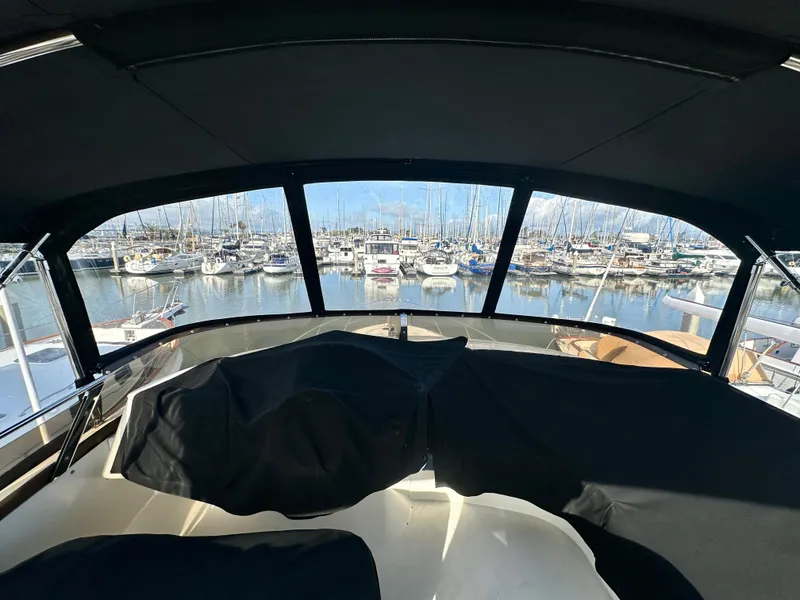 Slide: The Image of 2007 Viking Sport Cruiser interior with elegant seating and spiral staircase, docked at marina. - 11