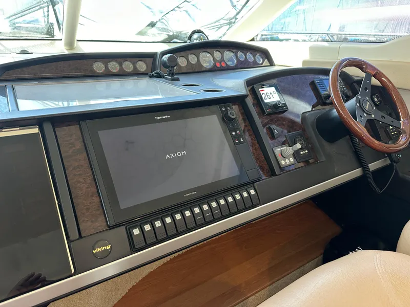 Slide: The Image of Luxurious interior of 2007 Viking Sport Cruiser yacht with elegant seating and wooden finishes. - 14