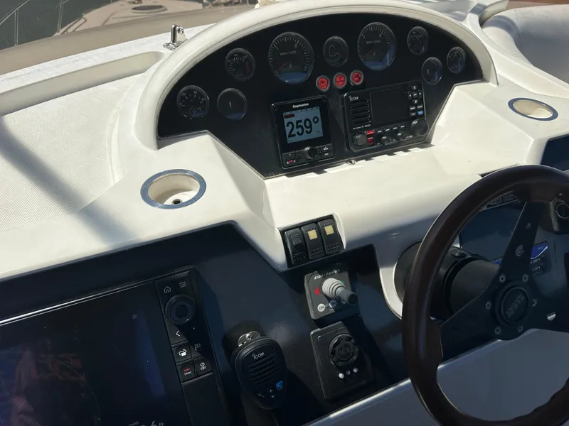 Slide: The Image of 2007 Viking Sport Cruiser dashboard with navigation display and wooden steering wheel. - 21