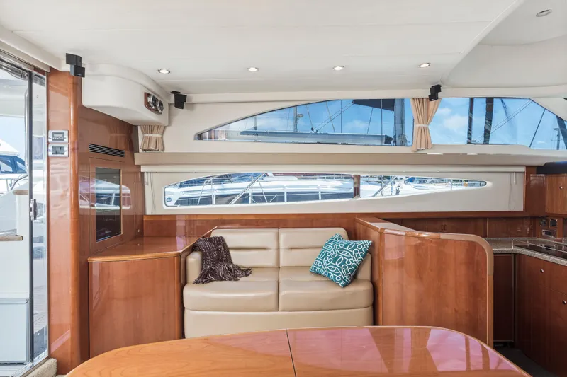 Slide: The Image of 2007 Viking Sport Cruiser yacht interior with seating and table, docked at marina. - 35