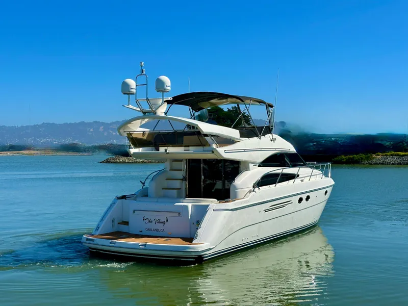 Slide: The Image of 2007 Viking Sport Cruiser yacht on calm water, clear sky background. - 4