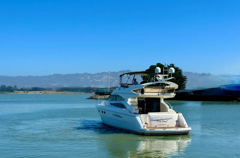 Slide: The Image of 2007 Viking Sport Cruiser yacht on calm water under clear blue sky. - 5
