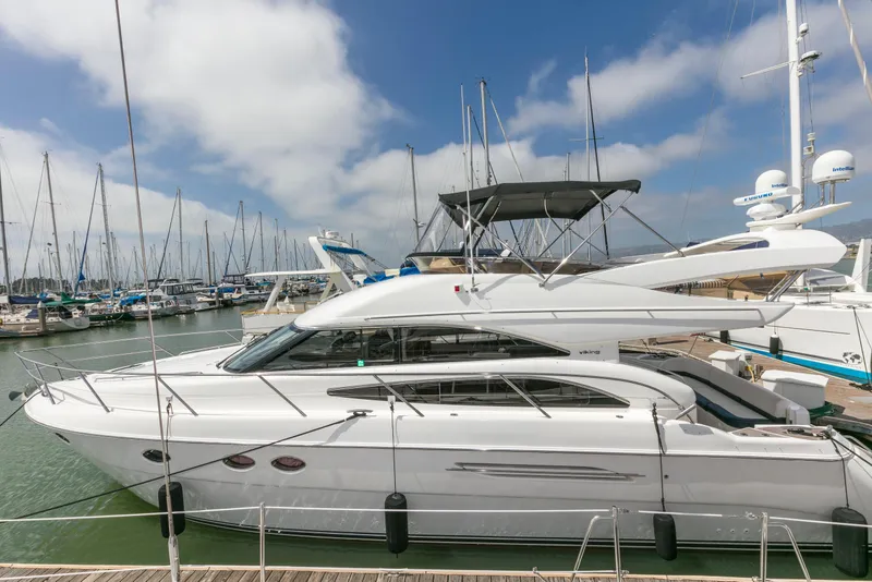 Slide: The Image of 2007 Viking Sport Cruiser yacht on calm water with scenic background. - 50
