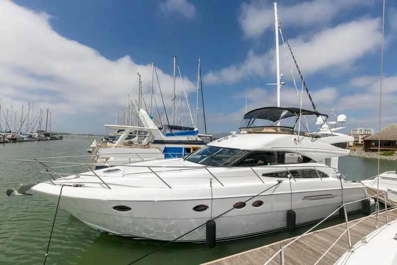 Slide: The Image of 2007 Viking Sport Cruiser yacht on calm water under clear blue sky. - 51