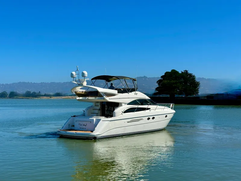 Slide: The Image of 2007 Viking Sport Cruiser yacht on calm water under clear blue sky. - 52