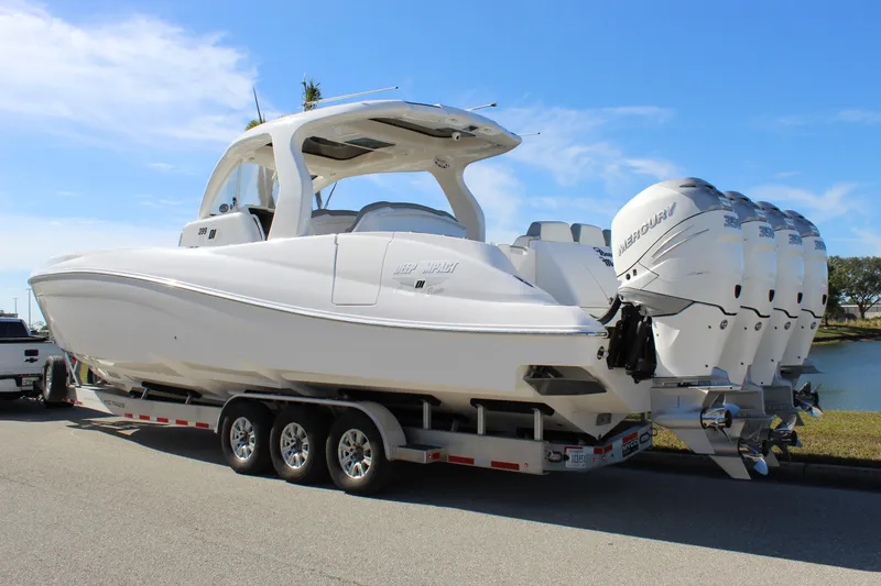 Slide: The Image of 2019 Deep Impact 399 Sport boat on trailer with multiple outboard engines. - 14