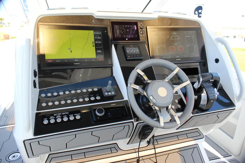 Slide: The Image of 2019 Deep Impact 399 Sport boat dashboard with navigation screens and controls. - 47
