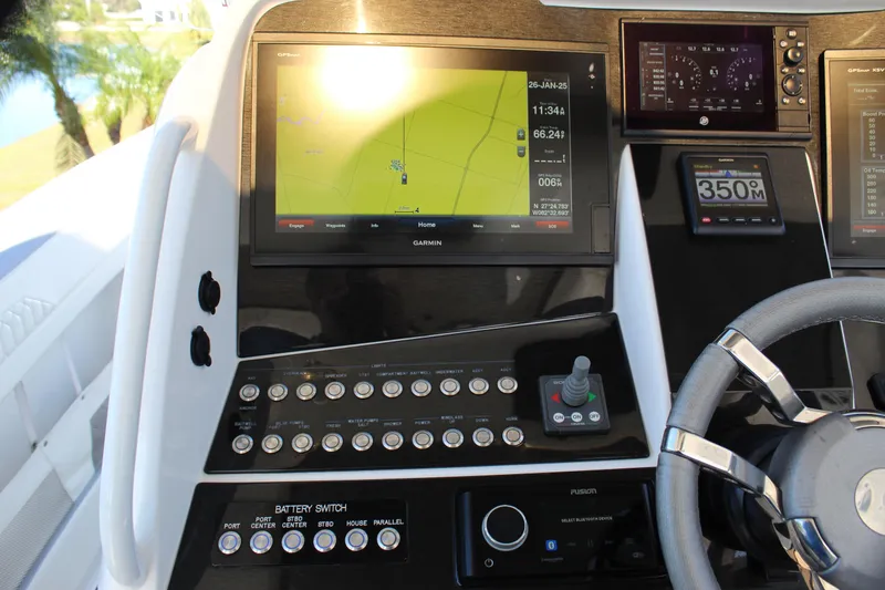 Slide: The Image of 2019 Deep Impact 399 Sport boat dashboard with navigation and control panels. - 49