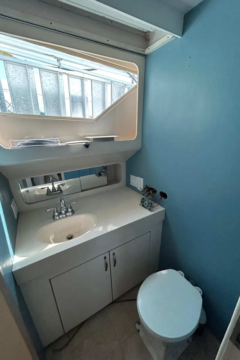 Slide: The Image of Bathroom interior of 1991 Hatteras Cockpit Motor Yacht with sink and toilet. - 18