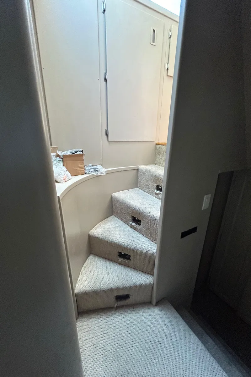 Slide: The Image of Interior stairs of a 1991 Hatteras Cockpit Motor Yacht, featuring carpeted steps. - 20