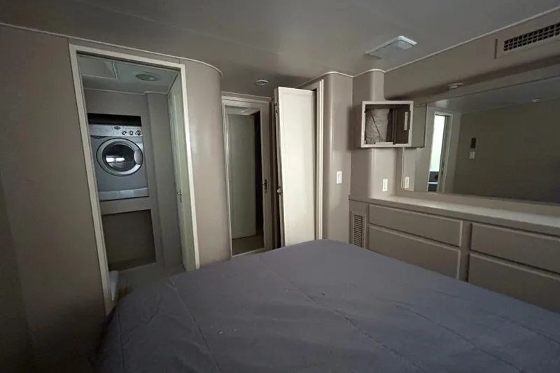 Slide: The Image of 1991 Hatteras Cockpit Motor Yacht interior with bedroom and laundry area. - 25