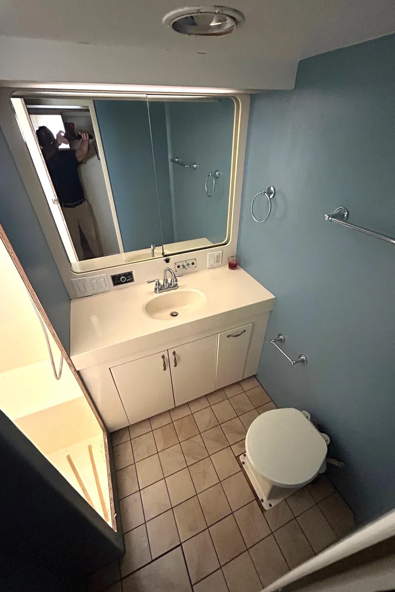 Slide: The Image of Bathroom interior of 1991 Hatteras Cockpit Motor Yacht with sink and toilet. - 27