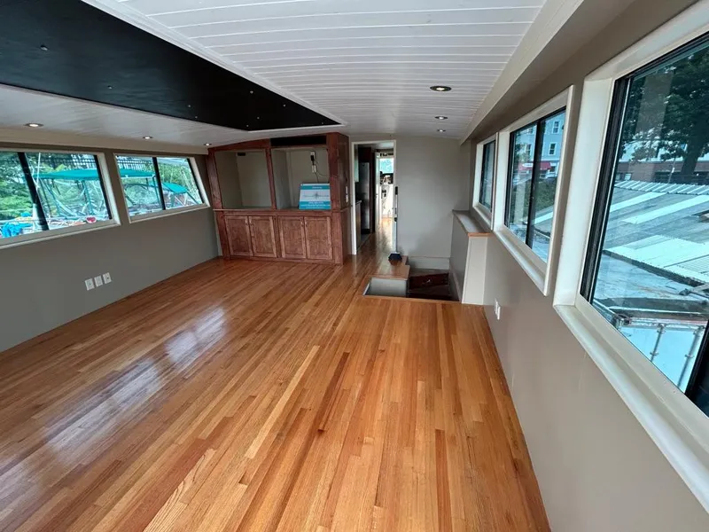 Slide: The Image of Spacious interior of 1991 Hatteras Cockpit Motor Yacht with wooden flooring and large windows. - 36