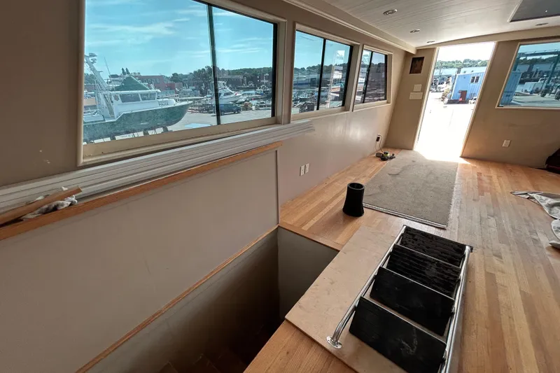 Slide: The Image of Interior of 1991 Hatteras Cockpit Motor Yacht with wooden flooring and large windows. - 37