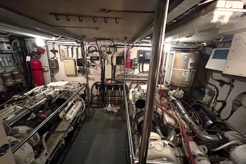 Slide: The Image of Engine room of a 1991 Hatteras Cockpit Motor Yacht, showcasing machinery and equipment. - 41