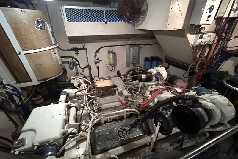 Slide: The Image of Engine room of a 1991 Hatteras Cockpit Motor Yacht, showcasing machinery and wiring. - 42