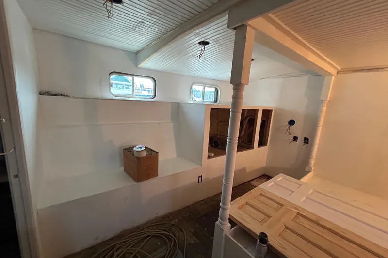 Slide: The Image of Interior renovation of a 1991 Hatteras Cockpit Motor Yacht with white walls and ceiling. - 8