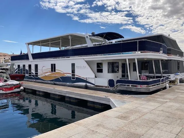 Slide: The Image of Deck of a 2008 Sharpe Kohala Sun Trip boat with table and seating area. - 4