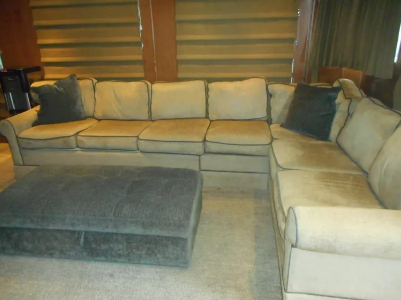 Slide: The Image of Beige sectional sofa with cushions in cozy living room. - 6