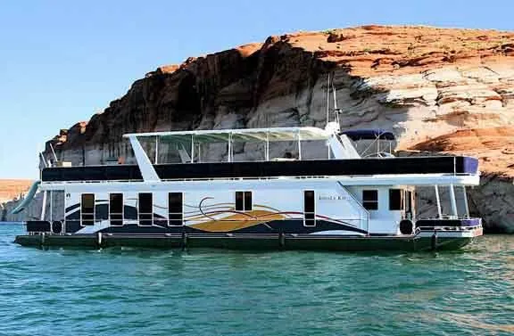 The Image of 2008 Sharpe Kohala Sun Trip houseboat near rocky shoreline. - 0