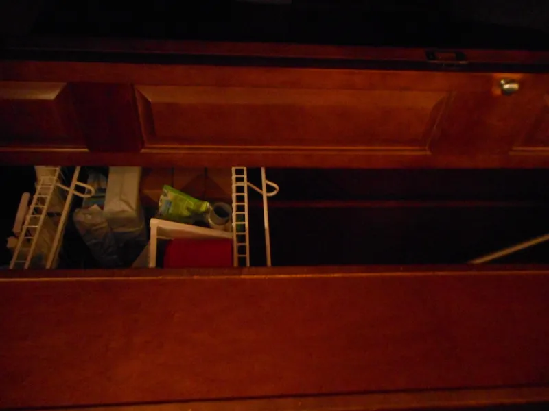 Slide: The Image of Open wooden cabinet with shelves and stored items. - 19