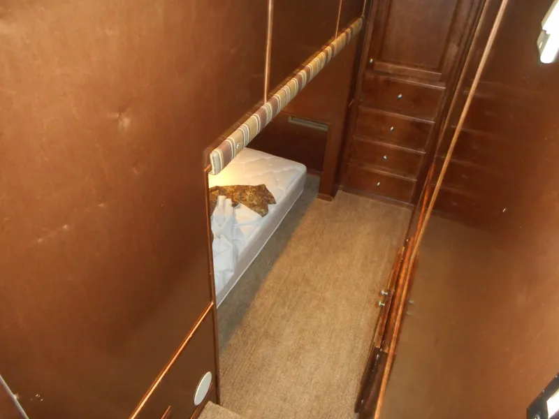 Slide: The Image of Interior of a 2008 Sharpe Kohala Sun Trip boat with bed and cabinets. - 26