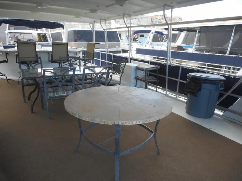 Slide: The Image of Deck area of a 2008 Sharpe Kohala Sun Trip boat with tables and chairs. - 44