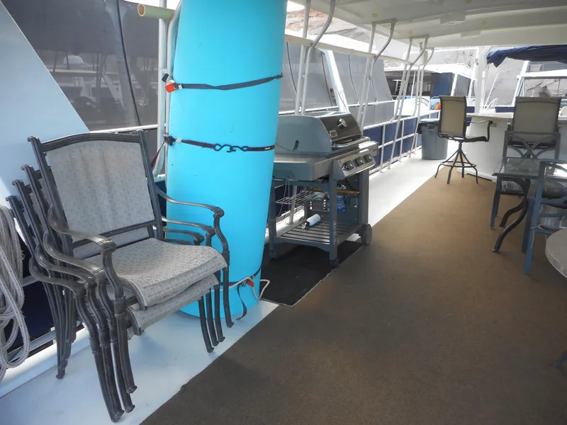 Slide: The Image of Deck of a Sharpe boat with grill and chairs, 2008. - 45