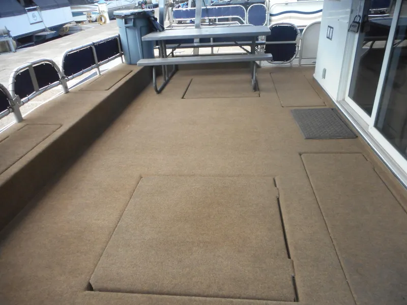 Slide: The Image of Deck of a 2008 Sharpe Kohala Sun Trip boat with table and seating area. - 7
