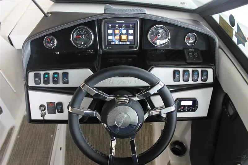 Slide: The Image of 2018 Bryant Potenza boat dashboard with steering wheel, gauges, and control panel. - 11