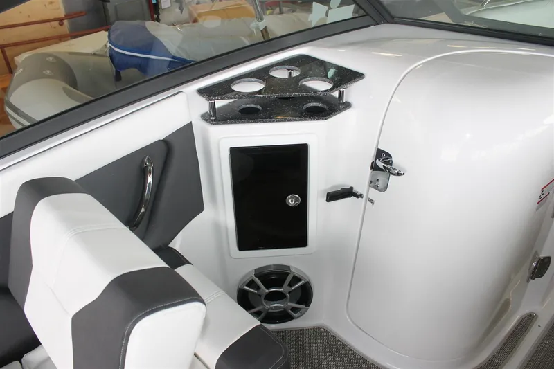 Slide: The Image of 2018 Bryant Potenza boat interior with cup holders, speaker, and storage compartment. - 13