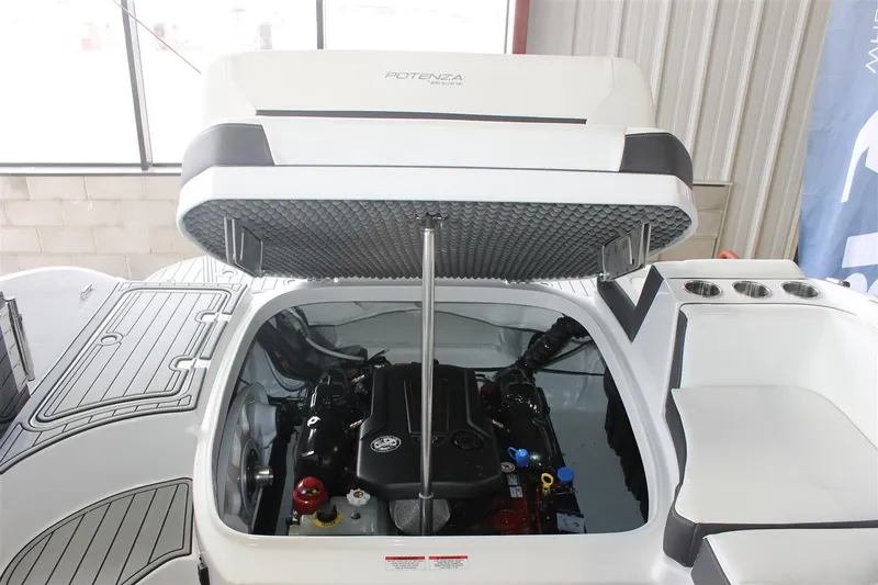 Slide: The Image of 2018 Bryant Potenza boat engine compartment with open hatch, showcasing engine details. - 16