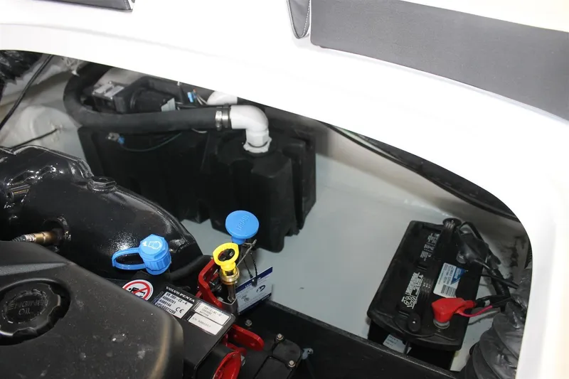 Slide: The Image of Engine compartment of a 2018 Bryant Potenza boat, showing battery and fluid caps. - 17