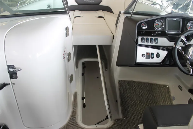 Slide: The Image of 2018 Bryant Potenza boat interior with open storage compartment and modern dashboard controls. - 20