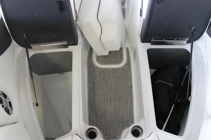 Slide: The Image of 2018 Bryant Potenza boat interior with open storage compartments and cup holders. - 23