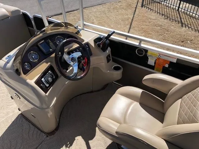 Slide: The Image of 2013 South Bay 726 CR boat interior with steering console and captain's chair. - 12