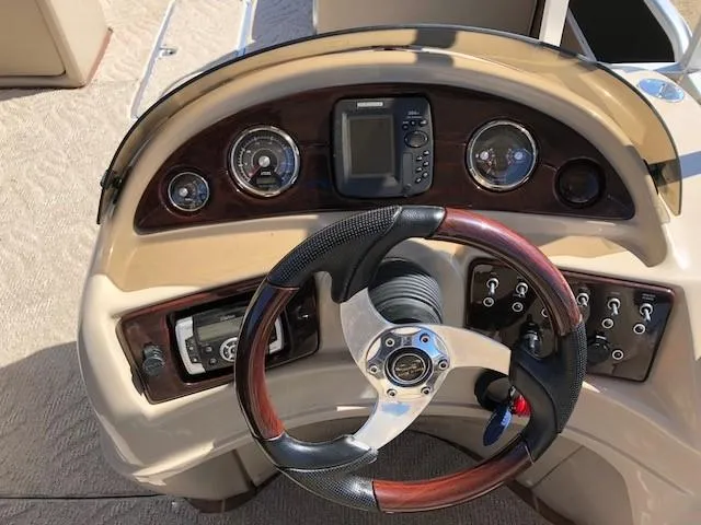 Slide: The Image of Steering console of 2013 South Bay 726 CR boat with gauges and controls. - 13