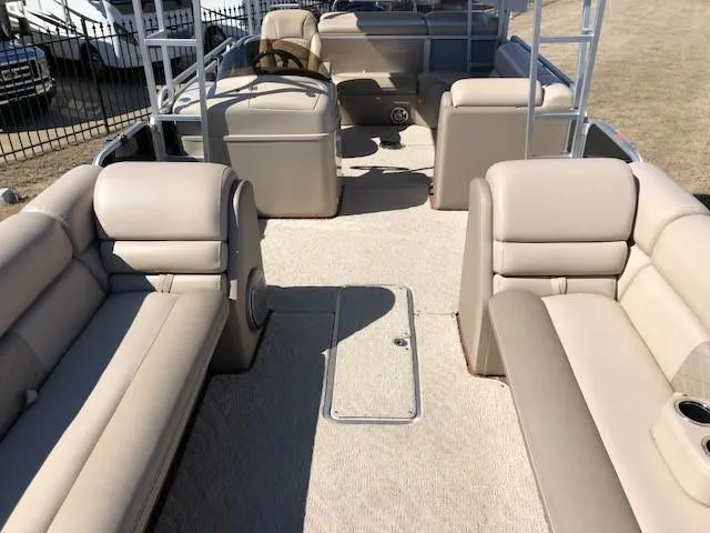 Slide: The Image of 2013 South Bay 726 CR pontoon boat interior with beige seating and steering console. - 17