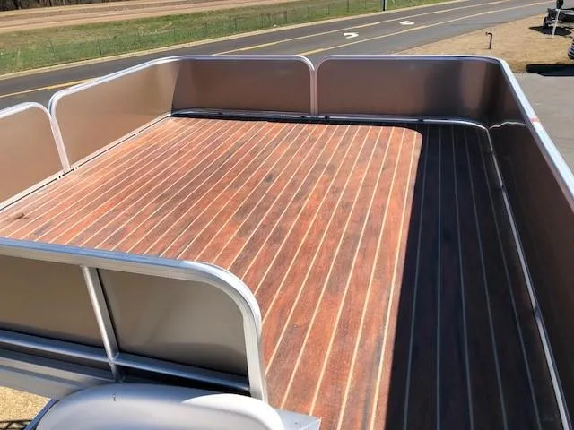 Slide: The Image of 2013 South Bay 726 CR boat deck with wood finish, viewed from above. - 18