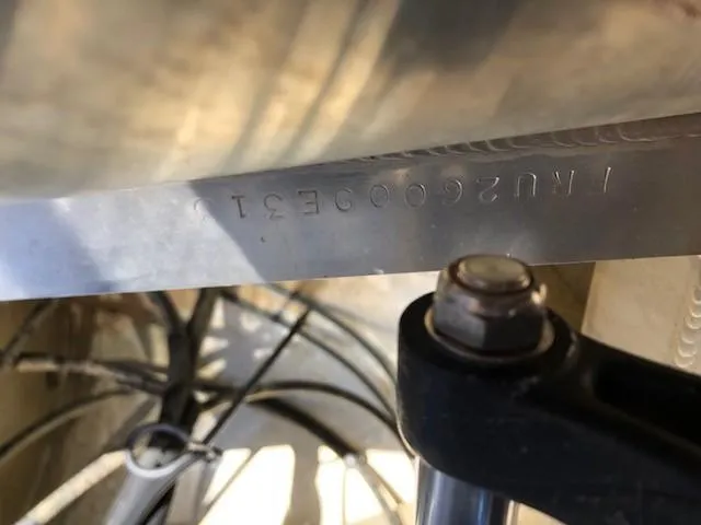 Slide: The Image of Close-up of South Bay 726 CR 2013 boat serial number and mechanical components. - 21