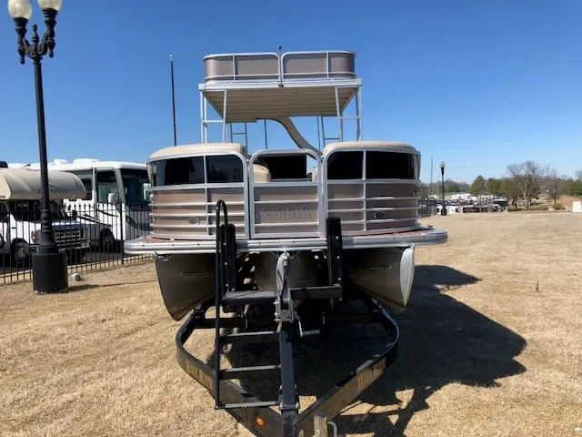 Slide: The Image of 2013 South Bay 726 CR pontoon boat on trailer, parked on grass. - 3
