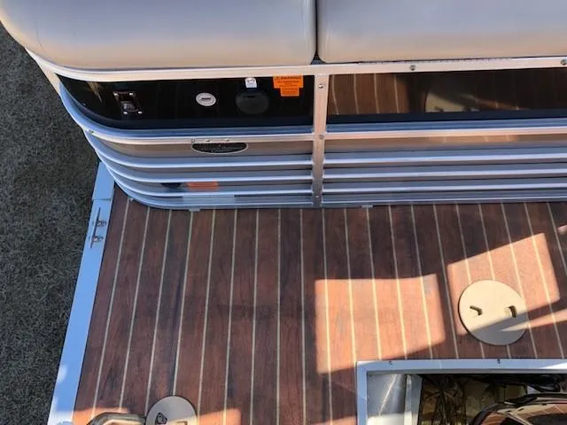 Slide: The Image of 2013 South Bay 726 CR pontoon boat deck with wood finish and seating area. - 9