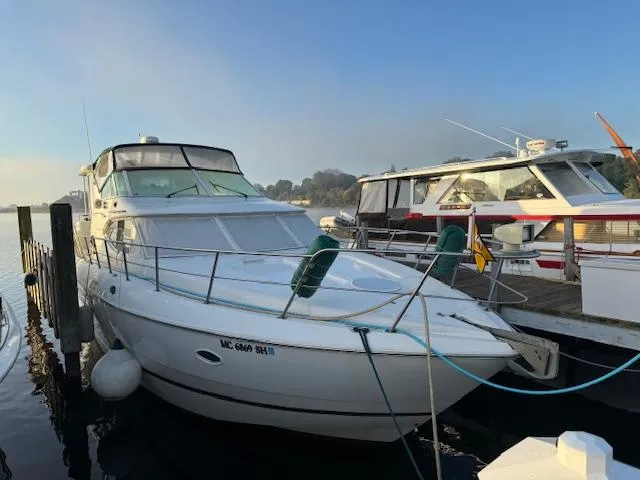 Slide: The Image of 2000 Cruisers Yachts 4450 Express Motor Yacht docked at marina, side view. - 10