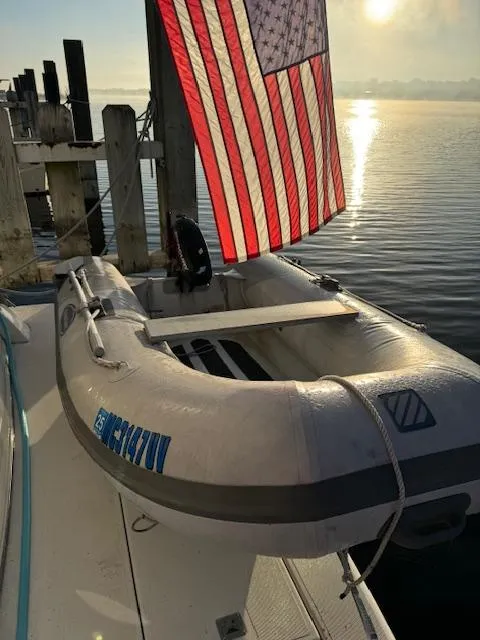 Slide: The Image of Inflatable boat on 2000 Cruisers Yachts 4450 Express Motor Yacht, docked with American flag. - 17